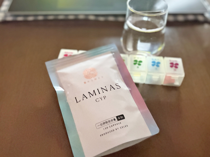 "LAMINAS CYP（ラミナスCYP）のパッケージと、1週間分の100均ピルケースに小分けされたサプリメント